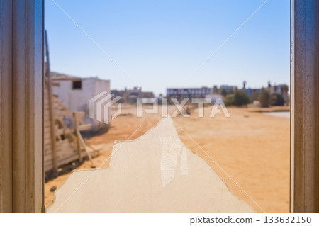 Broken window with desert landscape view Broken window with desert landscape view 133632150