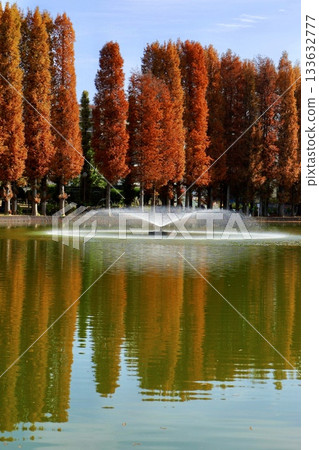 Autumn leaves, blue sky, a pond, and a fountain at Bessho Numa Park in Saitama Prefecture Autumn leaves, blue sky, a pond, and a fountain at Bessho Numa Park in Saitama Prefecture 133632777