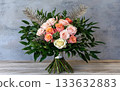 Peach rose bouquet pink rose cream rose green foliage gold fern wooden table concrete wall natural light 133632883