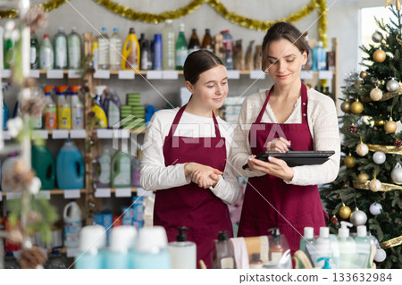 Mother and daughter using tablet to manage family store during holidays Mother and daughter using tablet to manage family store during holidays 133632984