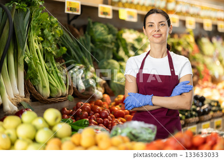 Portrait of female seller in interior of grocery supermarket Portrait of female seller in interior of grocery supermarket 133633033