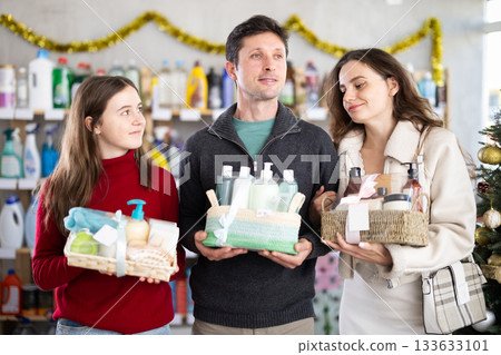 Family shopping for Christmas presents together in supermarket Family shopping for Christmas presents together in supermarket 133633101