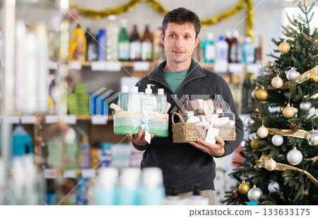 Adult man buyer chooses cosmetics gift set for christmas Adult man buyer chooses cosmetics gift set for christmas 133633175
