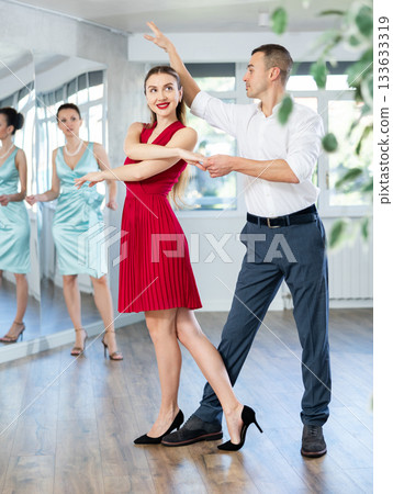 Elegant couple rehearsing sensual wedding dance in studio Elegant couple rehearsing sensual wedding dance in studio 133633319