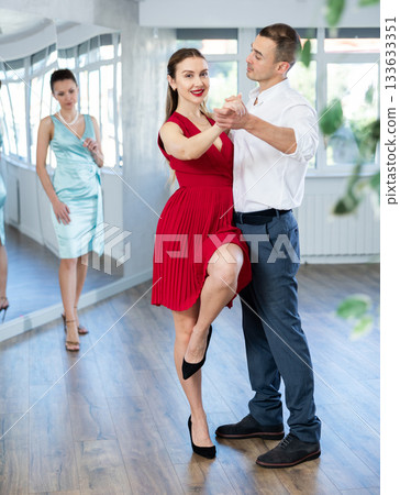 Elegant couple rehearsing sensual wedding dance in studio Elegant couple rehearsing sensual wedding dance in studio 133633351