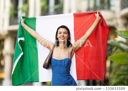 Portrait of brunette girl with Italy flag on street of city Portrait of brunette girl with Italy flag on street of city 133633389