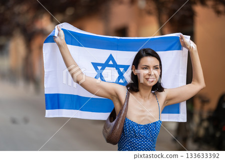 Young woman with israeli flag on city street Young woman with israeli flag on city street 133633392