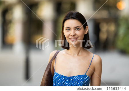 Young woman posing on city street Young woman posing on city street 133633444
