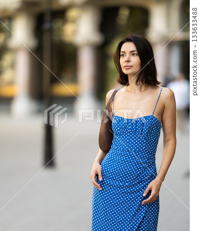 Young woman posing on city street 133633488