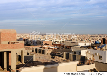 Expansive urban landscape with city skyline and architecture under construction 133633528