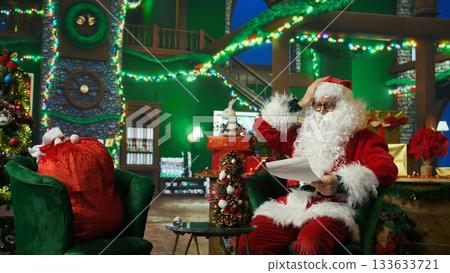 Santa Claus shakes head, doing thumbs down sign, disagreeing with letters from kids. Person in Christmas costume doing negative rejection gesturing regarding wish lists from children, camera A 133633721