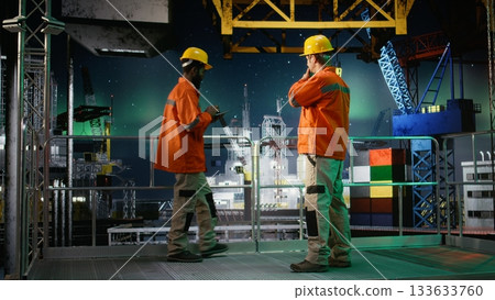 Offshore engineer coordinating via walkie talkie during oil production operations, natural gas emission monitoring under northern lights. Compliance with oil extraction rules. 133633760