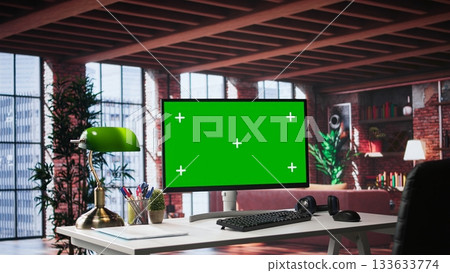 Refined office setup in classy loft with green screen monitor for mockups use. Chic interior design and upscale furniture reflect a serene, creative and exclusive environment. Spacious home. Refined office setup in classy loft with green screen monitor for mockups use. Chic interior design and upscale furniture reflect a serene, creative and exclusive environment. Spacious home. 133633774