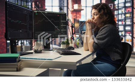 Day trader feeling worried and stressed looking at monetary losses, analyzing stock price trends on pc. Exasperated woman losing shares and dealing with market crash, trading decisions. Camera A. Day trader feeling worried and stressed looking at monetary losses, analyzing stock price trends on pc. Exasperated woman losing shares and dealing with market crash, trading decisions. Camera A. 133633842