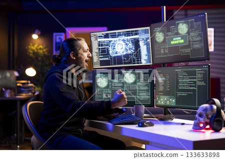 Jolly man celebrating after stealing sensitive information using VPN on dark web. Hacker happy after seeing access granted message on computer, breaking into systems to take restricted data 133633898