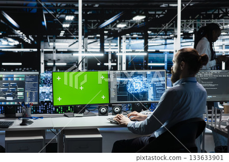 Developer in data center using isolated screen PC, optimizing gear for AI tasks, increasing workloads. Server room IT worker automating system diagnostics using deep learning on chroma key computer 133633901