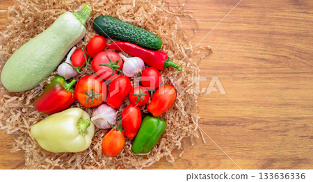 Composition of fresh vegetables on a wooden surface 133636336