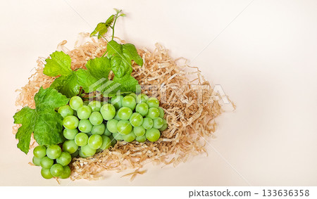 Green grapes on a beige background, composition Green grapes on a beige background, composition 133636358