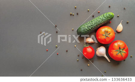 Composition of tomato, cucumber and head of garlic on gray background, top view with space for text Composition of tomato, cucumber and head of garlic on gray background, top view with space for text 133636433