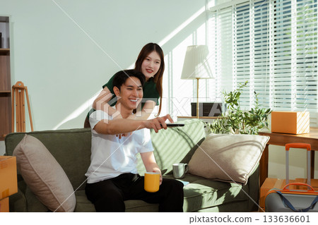 young couple helps put things in boxes and prepares to move to a new house. 133636601