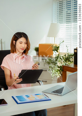 Woman start up small business owner at workplace. small business entrepreneur SME or freelance asian woman working with box at home. 133636663