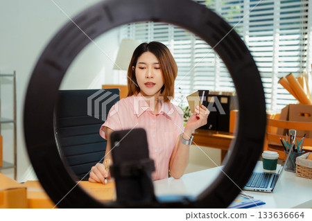 Small business entrepreneur SME freelance woman working at home office, boxs ,tablet and laptop online, marketing, packaging, delivery, e-commerce concept. Small business entrepreneur SME freelance woman working at home office, boxs ,tablet and laptop online, marketing, packaging, delivery, e-commerce concept. 133636664