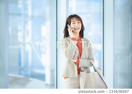 A woman talking on a smartphone 133636897
