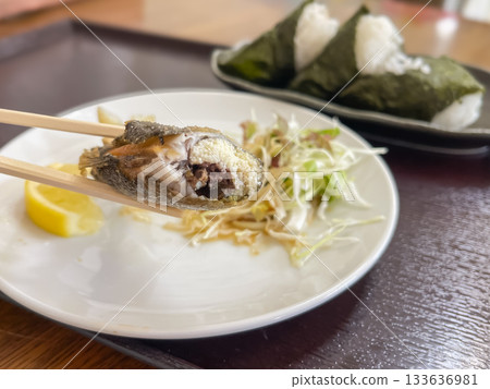 Ayu, a mountain stream fish. A Japanese dish of deep-fried sweetfish with eggs and rice balls wrapped in seaweed. A close-up of the eggs. 133636981