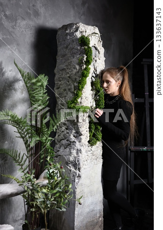 Minimalist black attire accentuated by nature and stone architecture Minimalist black attire accentuated by nature and stone architecture 133637143