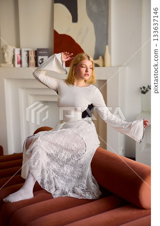 Blonde woman moves gracefully while relaxing in domestic setting Blonde woman moves gracefully while relaxing in domestic setting 133637146