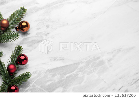 Festive Christmas ornament, pine branches with christmas balls on marble table background, top view Festive Christmas ornament, pine branches with christmas balls on marble table background, top view 133637200