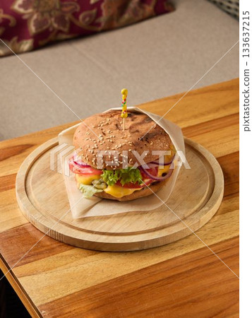 burger with toppings, gourmet burger served on wooden surface with fresh toppings and inviting ambiance burger with toppings, gourmet burger served on wooden surface with fresh toppings and inviting ambiance 133637215