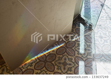 sunshine illuminates vintage tiled flooring, shadow patterns dance over textured plaster wall sunshine illuminates vintage tiled flooring, shadow patterns dance over textured plaster wall 133637249