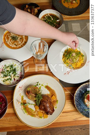 An Assortment of Various Deliciously Prepared HomeCooked Dishes Arranged on a Wooden Table An Assortment of Various Deliciously Prepared HomeCooked Dishes Arranged on a Wooden Table 133637377