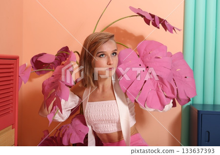 Stylish woman amongst greenery, Chic female model with vibrant foliage Stylish woman amongst greenery, Chic female model with vibrant foliage 133637393