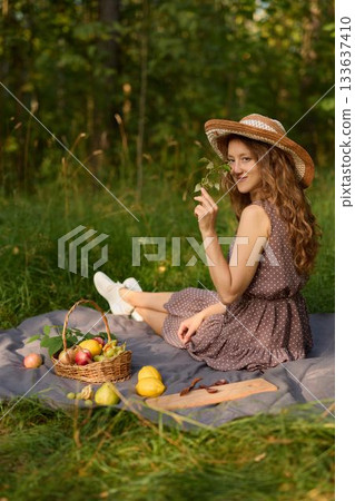 Woman daydreaming outdoors, Picnic lady with floral charm Woman daydreaming outdoors, Picnic lady with floral charm 133637410