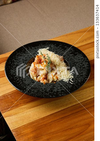 delicious seafood dinner, intimate evening meal featuring rich shrimp risotto on rustic wooden table delicious seafood dinner, intimate evening meal featuring rich shrimp risotto on rustic wooden table 133637414