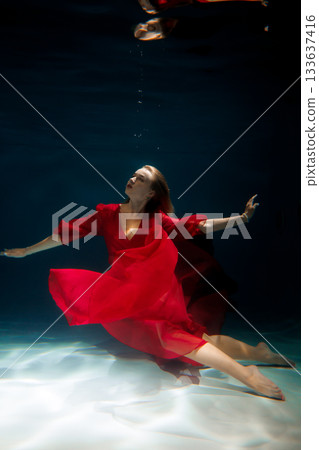 Mythical underwater display with flowing gown and reflections 133637416