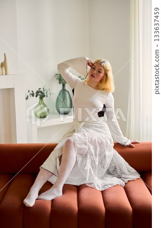 Serene female figure with flowing dress amid artistic greenery 133637459