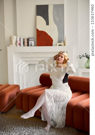Serene female artist lost in creative reflection indoors 133637460