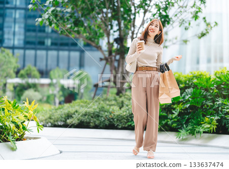 Single adult asian woman holding take away coffee cup and shopping bag city people lifestyle Single adult asian woman holding take away coffee cup and shopping bag city people lifestyle 133637474