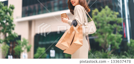 Single adult asian woman holding take away coffee cup and shopping bag city people lifestyle Single adult asian woman holding take away coffee cup and shopping bag city people lifestyle 133637478