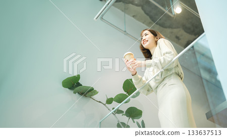 Adult asian business woman relax drinking coffee at indoors cafe Adult asian business woman relax drinking coffee at indoors cafe 133637513