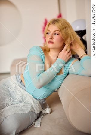 reflective woman from europe lounging softly amidst warm lighting and ornamental decorations reflective woman from europe lounging softly amidst warm lighting and ornamental decorations 133637546