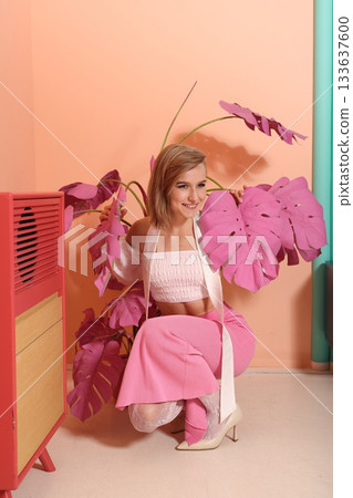 Comfortable pose amid vibrant plants and nostalgic furnishings Comfortable pose amid vibrant plants and nostalgic furnishings 133637600