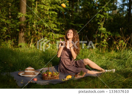Joyful sunny picnic, She enjoys warm sun with tasty treats outside Joyful sunny picnic, She enjoys warm sun with tasty treats outside 133637610