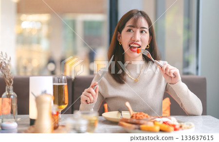 Joyful adult business asian single woman eating lunch tasty menu elegant foodie happy lifestyle 133637615