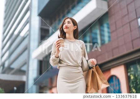 Single adult business asian woman holding coffee cup and shopping bag city people lifestyle Single adult business asian woman holding coffee cup and shopping bag city people lifestyle 133637618