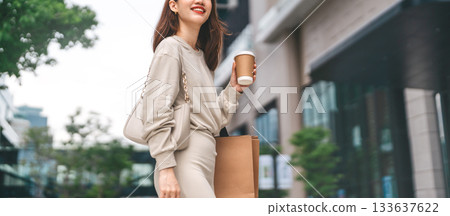 Single adult business asian woman holding coffee cup and shopping bag city people lifestyle 133637622