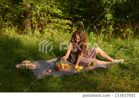 Harvesting seasonal apples, Young lady picks apples on sunny day Harvesting seasonal apples, Young lady picks apples on sunny day 133637681